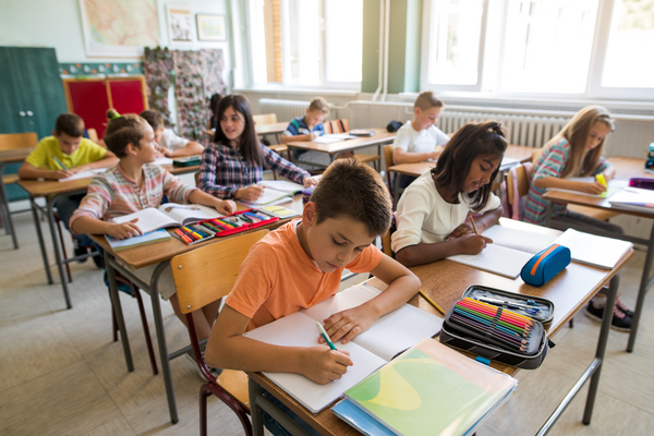 Students in a classroom busy working on a written exercise