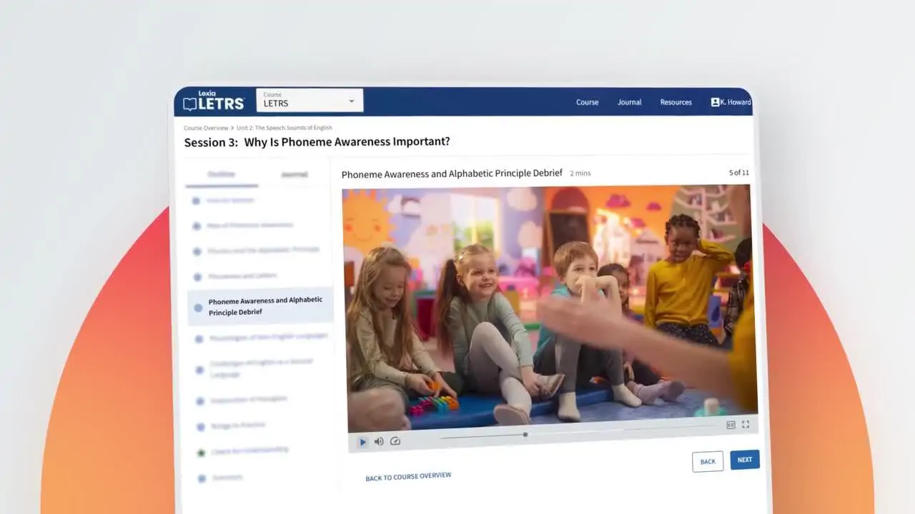 Four children sit on a classroom floor, smiling and engaging with a teacher in a colorful, playful setting.